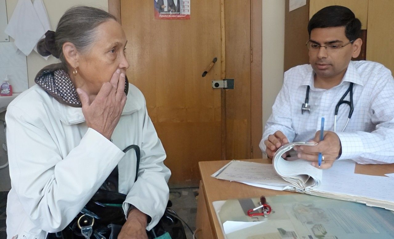 Doctor consulting an older patient at a clinic