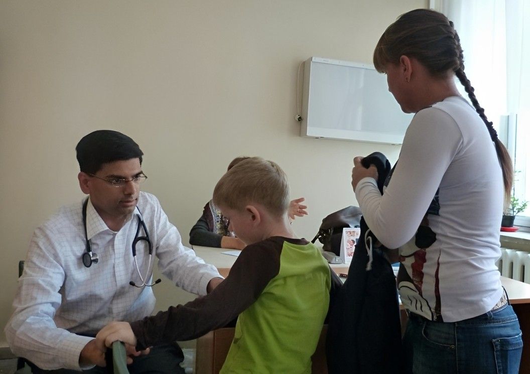 Doctor with a child and parent during a clinic visit