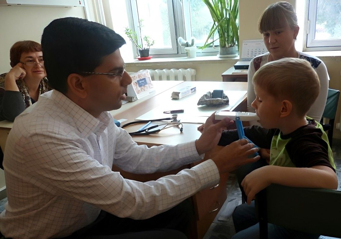 Physician helping a child with a breathing test