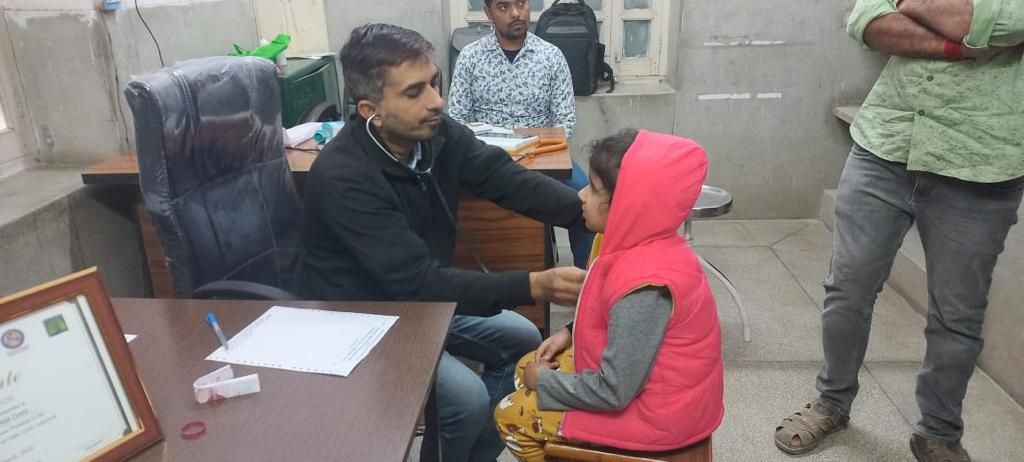 Physician examining a child at a PRAANA clinic